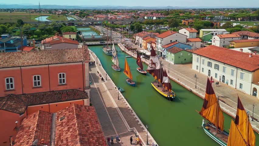 Aerial view of historic sailing boats in the port canal of Cesenatico, Emilia Romagna. The canal was surveyed and drawn by Leonardo da Vinci and is a famous landmark in Italy.