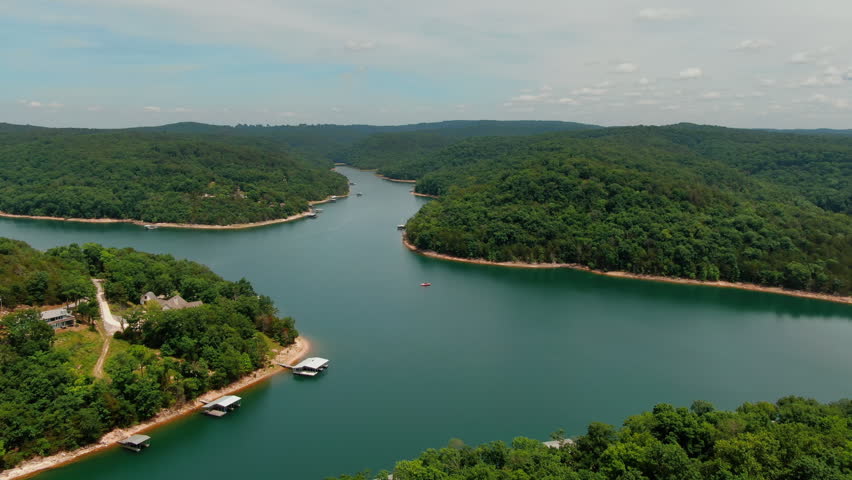 Aerial, slow pan right shot of waters of Beaver Lake and its lush vegetation. Arkansas, USA