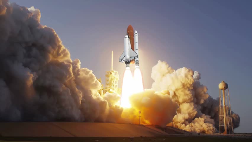 Space Shuttle lifting off with roaring bright engines and massive billowing clouds of launch smoke