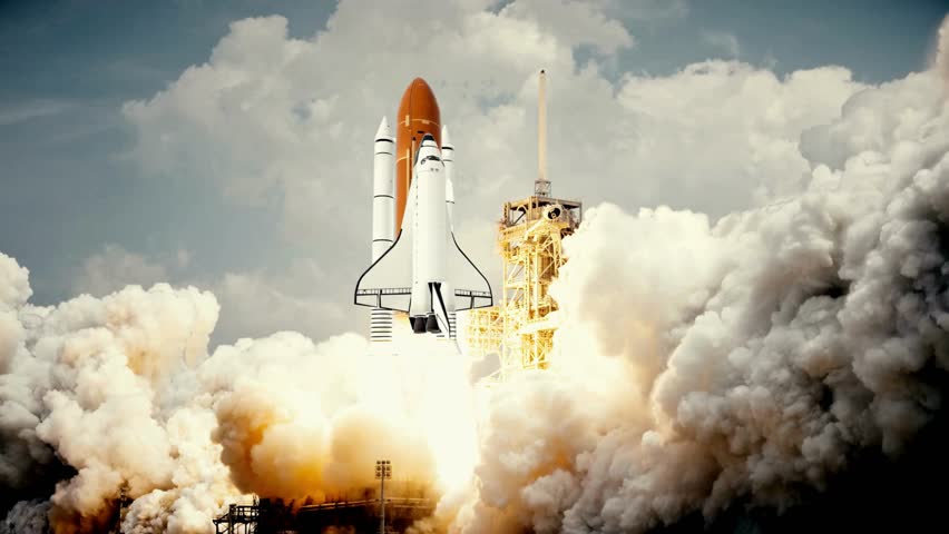 Space Shuttle liftoff from the launch pad surrounded by massive plumes of white smoke