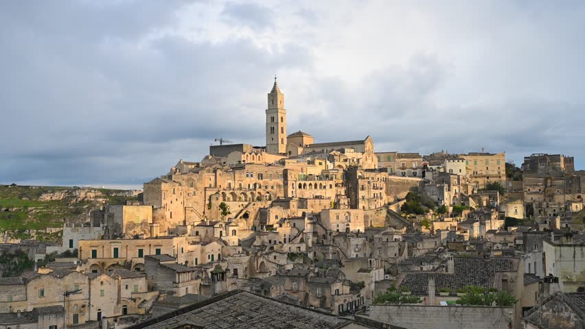 Matera, Italy, stone city on a hill, cathedral tower, stone and cave houses