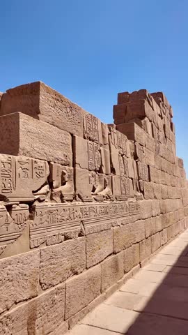Detailed hieroglyphic carvings and bas reliefs on a sandstone wall at the ancient philae temple in aswan, egypt