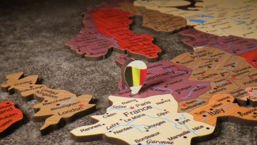 Wooden map of europe with belgium flag pin showing its location.