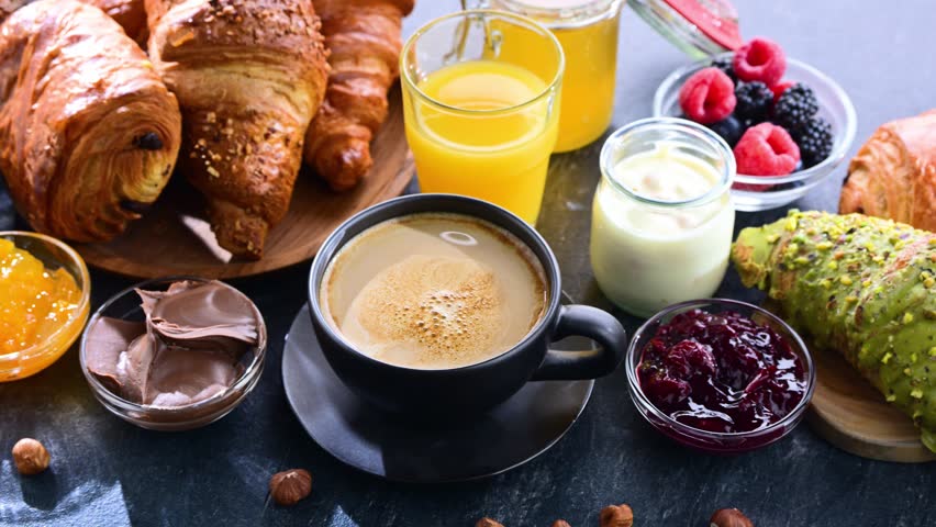 Italian breakfast served with croissants, orange juice, coffee and sweet extrass.