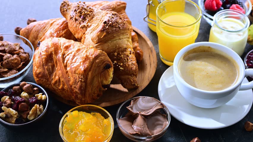 Italian breakfast served with croissants, orange juice, coffee and sweet extrass.