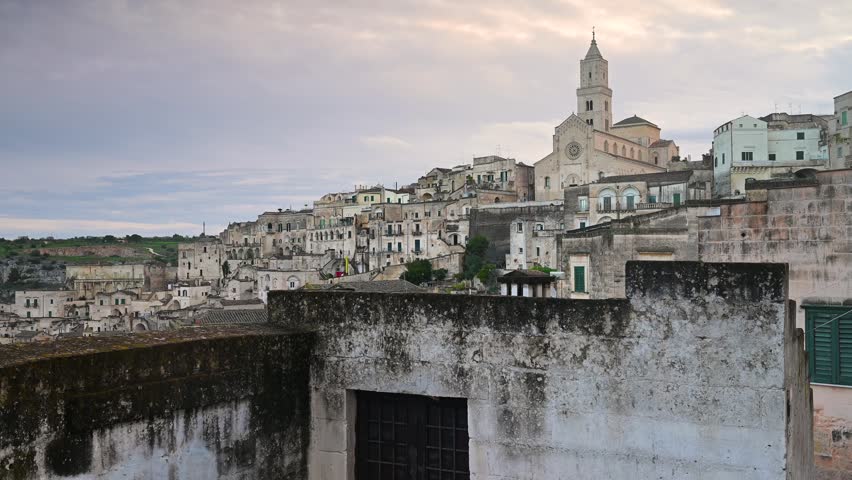 Matera, Italy, stone city on a hill, cathedral tower, stone and cave houses