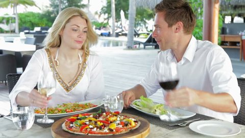 Couple Enjoying Meal In Outdoor Restaurant
