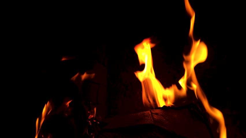 Fire burning in a chimney. Abstract slow motion flames in the dark.