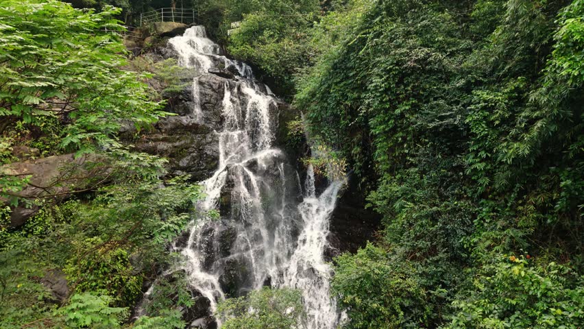 Close View Of Rushing Waters. Photograph Capturing Fastmoving Whitewater At Tourist Walkway Scene. Vivid Closeup Of Rugged Waterfall With Splashing White Water At Phong Nha Park