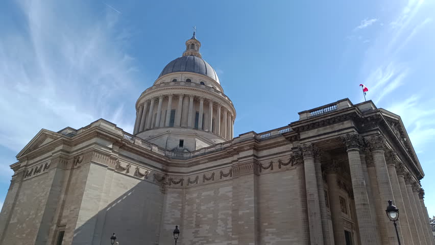 Historic Pantheon Mausoleum with its iconic dome and columns against a blue sky in Paris, France