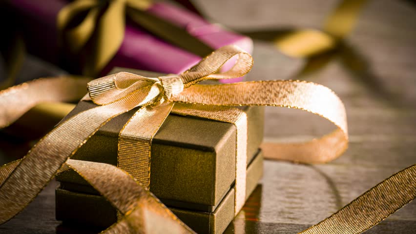 Brown Gift Boxes with Gold Ribbon Bow on Wooden Table Christmas Birthday Present Celebration Scene
