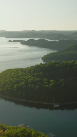 Vertical aerial tilt down shot over woods of Beaver Lake natural shoreline, Arkansas, USA