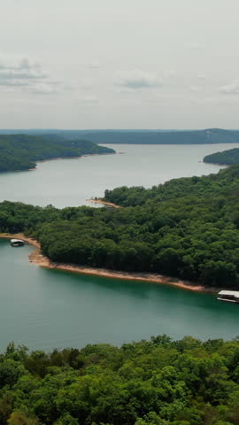 Vertical aerial shot over woods of Beaver Lake natural shoreline, Arkansas, USA