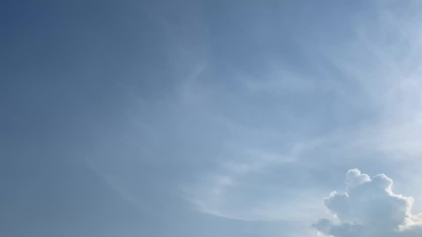4K bright sun shining through dramatic clouds above Jakarta, Indonesia. Upward view with soft lens flare, vivid blue sky and natural light, ideal for weather, energy, inspiration and nature themes.