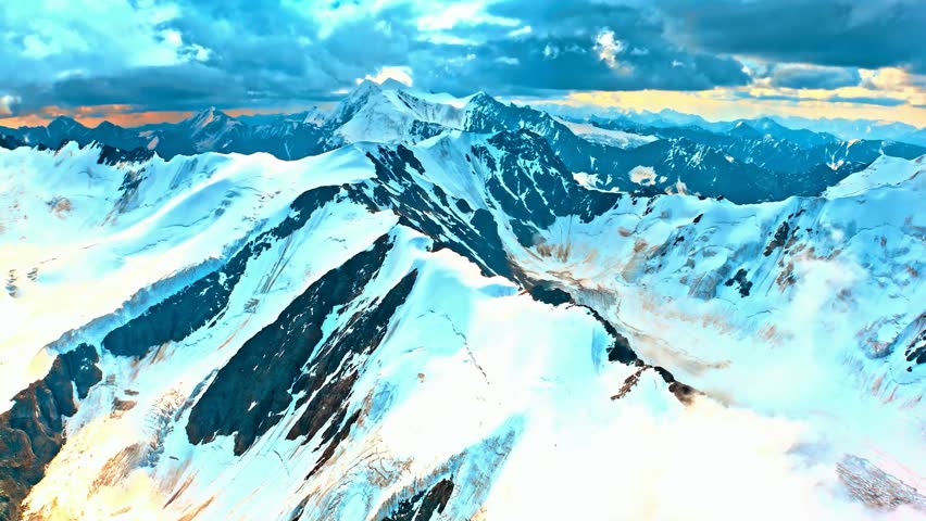 video captures Detailed aerial vista of expansive snow-covered mountain range, featuring towering peaks and valleys under vibrant sky. Clouds drift gently across, enhancing the dramatic natural beauty.
