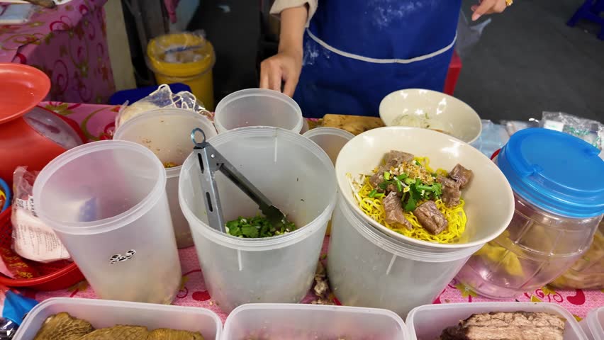 Thai Street Food Vendor Preparing Egg Noodles with Braised Duck Meat