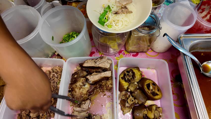 Thai Street Food Vendor Preparing Egg Noodles with Braised Duck Meat