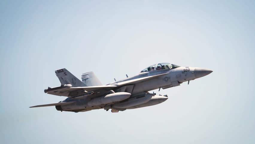 Twin-Seat Strike Fighter Soars Through Clear Skies, Demonstrating Combat Readiness and Mission Versatility.