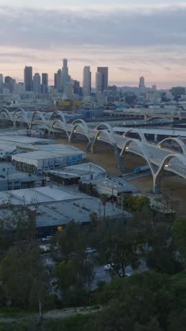 Aerial panoramic twilight view of 6th Street Viaduct and downtown skyscrapers in background. Los Angeles, California, USA
