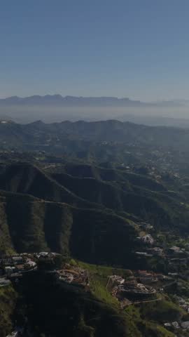 Nice aerial panoramic shot of houses in hills above city. Luxury addresses in Hollywood Hills. Los Angeles, California, USA