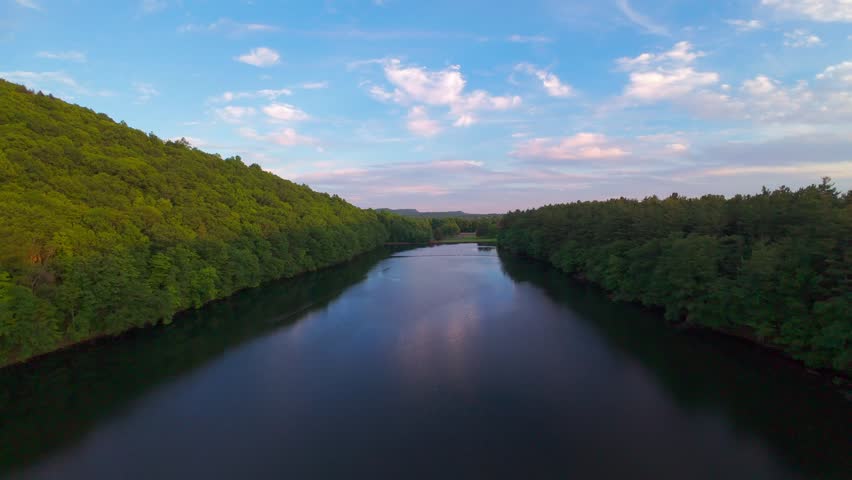 Summer aerial view featuring the Bradley Hubbard Reservoir at Doctor Francis Giuffrida Park and Chauncey Peak in Meriden, Connecticut just before sunset