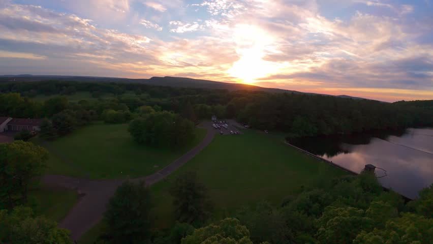 Summer aerial view featuring the Bradley Hubbard Reservoir at Doctor Francis Giuffrida Park and Chauncey Peak in Meriden, Connecticut just before sunset
