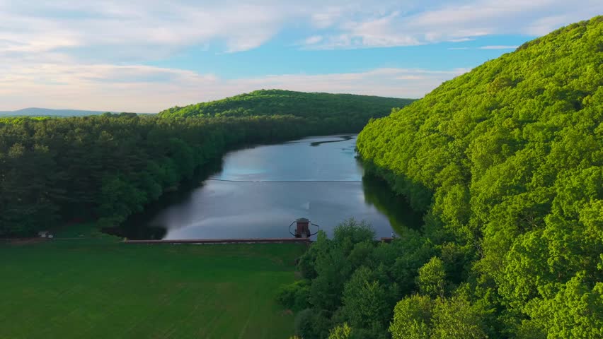 Summer aerial view featuring the Bradley Hubbard Reservoir at Doctor Francis Giuffrida Park and Chauncey Peak in Meriden, Connecticut just before sunset
