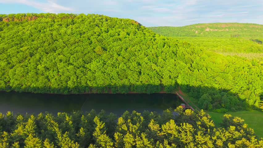 Summer aerial view featuring the Bradley Hubbard Reservoir at Doctor Francis Giuffrida Park and Chauncey Peak in Meriden, Connecticut just before sunset