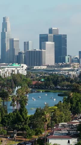 Los Angeles downtown skyline with Echo Park lake in foreground, modern office buildings, financial district towers, residential homes on a sunny California day