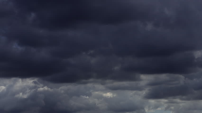Timelapse of dark storm clouds rapidly forming and moving across the sky.