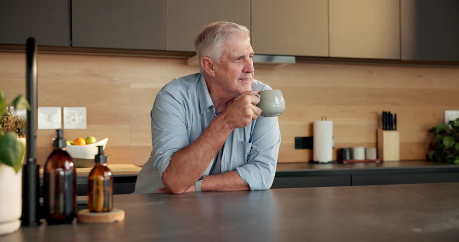 Thinking, coffee and senior man in kitchen for smile, morning peace and reflection for mindfulness. Vision, calm and elderly person with caffeine beverage for break, remember and nostalgia in home