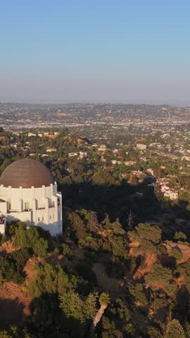 Griffith Observatory overlooking Los Angeles downtown skyline with Hollywood Hills and Griffith Park landscape on Mount Hollywood in Southern California