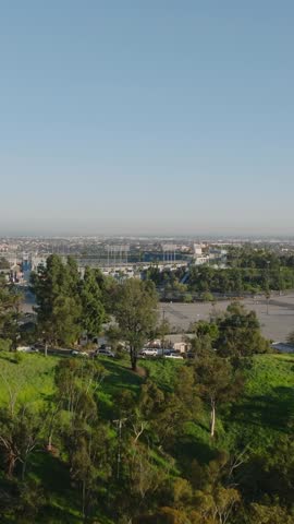 Aerial footage of large empty car park and sports arena. Famous Dodger Stadium at golden hour. Los Angeles, California, USA