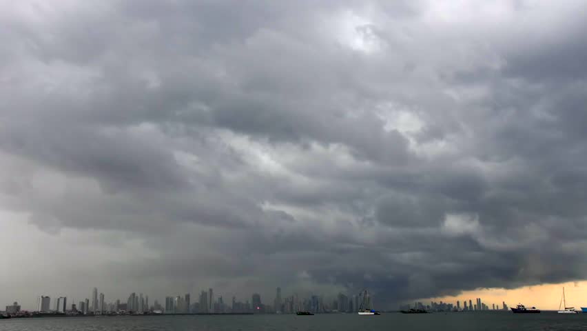 Dramatic timelapse of towering storm clouds moving across the skyline of Panama City, Panama. Dark atmospheric clouds gather above the urban waterfront as changing weather conditions unfold over the city. Ideal footage for themes of meteorology, climate, nature, urban landscapes, severe weather, and environmental change.