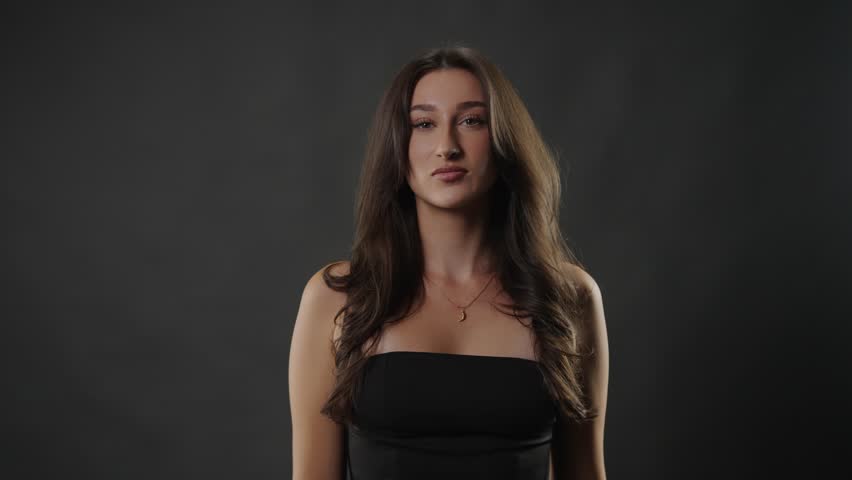 Female model beauty portrait a confident woman posing in a studio, embodying fashion and lifestyle concepts. Modern elegance and self care are highlighted through her poised demeanor and attractive fe