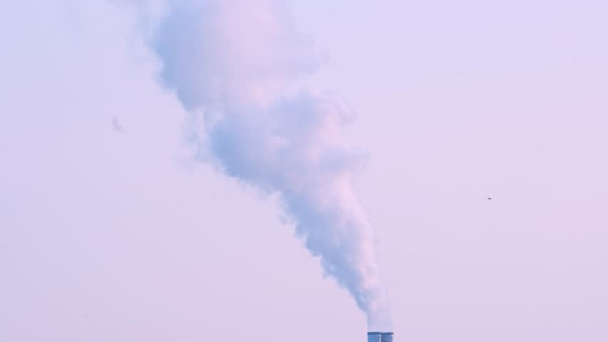 dramatic view factory with steam coming out of chimney, rising into sky, power and might of modern industry, with factory symbolizing production and innovation that drives global economy