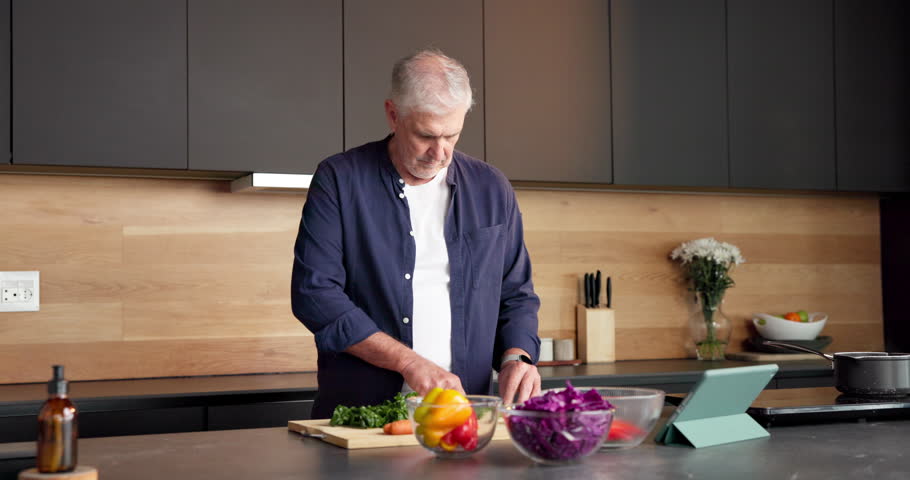 Face, home and old man with vegetables, cooking and confidence with tablet, recipe and smile. Happy, pensioner and senior person in kitchen, skills and ingredients with meal prep, health and food