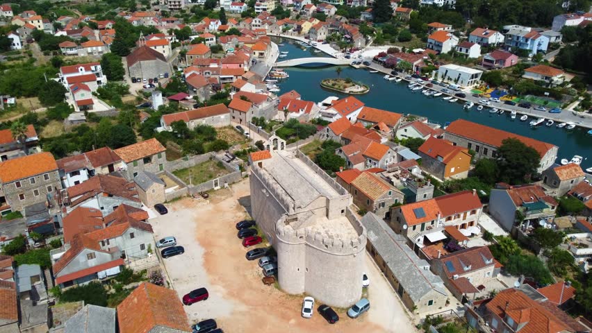 Picturesque aerial view slowly revealing the harbor of vrboska, a charming coastal town on hvar island, croatia, with its marina and village