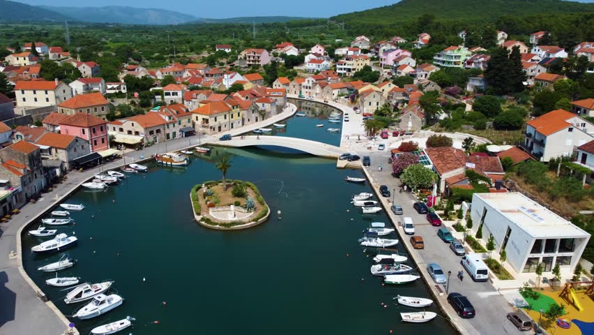 Beautiful aerial view of the town of vrboska on the island of hvar, croatia. The shot showcases the picturesque harbor with moored boats