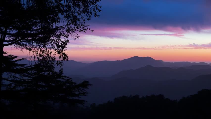 serene sunset landscape with mountain silhouettes and vibrant gradient sky colors