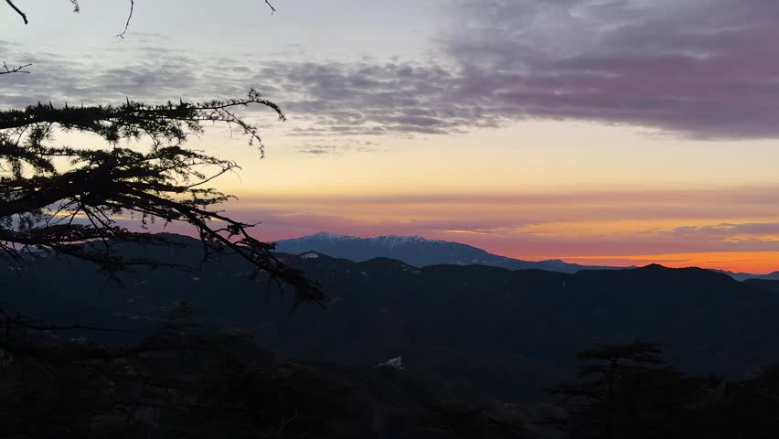 serene sunset panorama over majestic mountain ranges and glowing horizon colors
