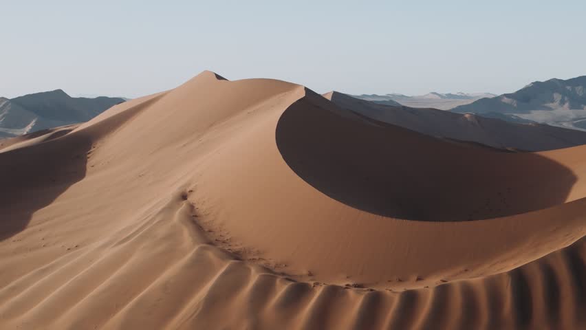 Aerial view of the sand dunes of sossusvlei, namib desert, with stunning light and shadow play.