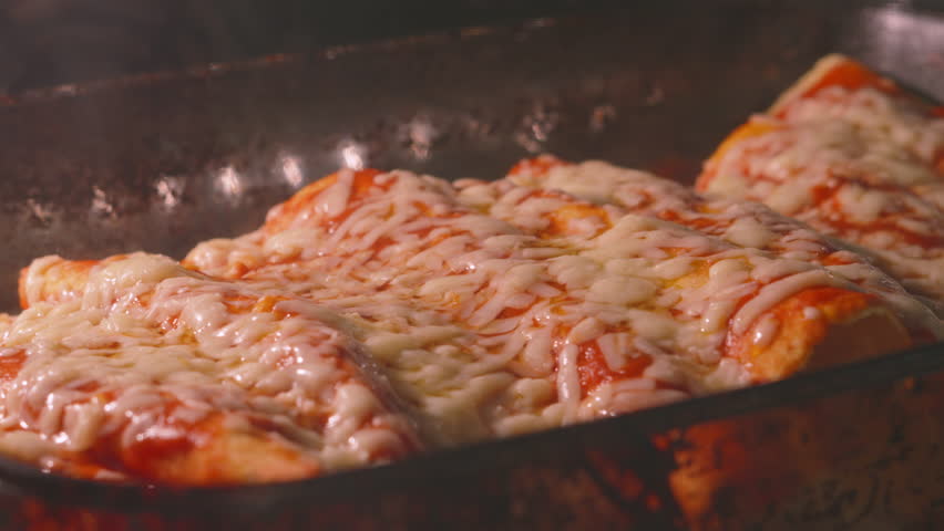 Timelapse of Mexican Chicken Enchiladas with Melting Cheese Bubbling in Hot Oven.