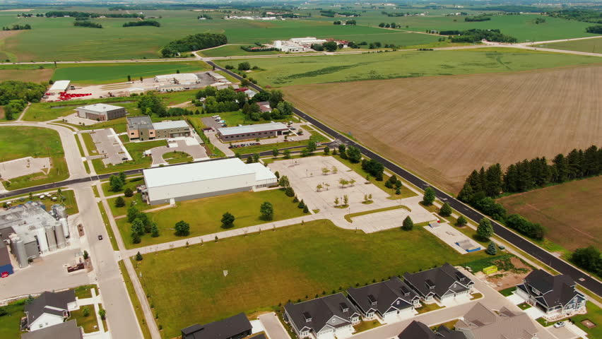 Aerial Tilt-Up of distant Highway with Cars Against the Farm Landscape of Waunakee, Wisconsin