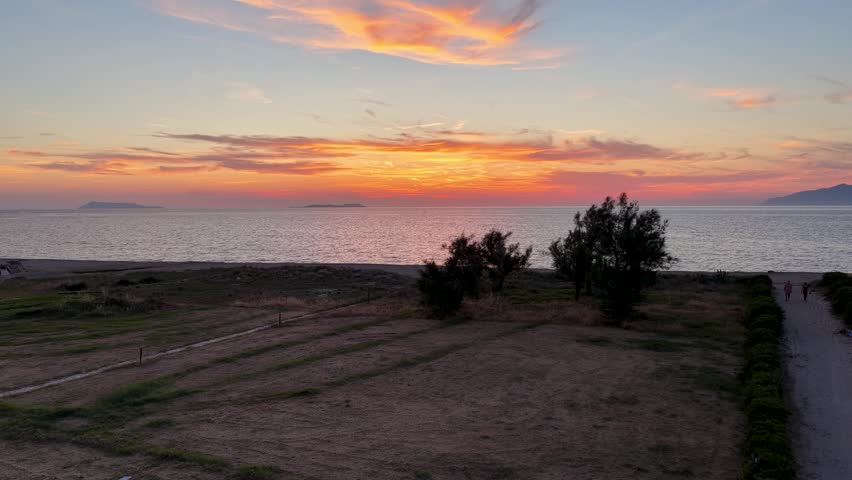 Aerial View of Golden Sunset Over Sea Beach in North Corfu Greece - Drone Shot