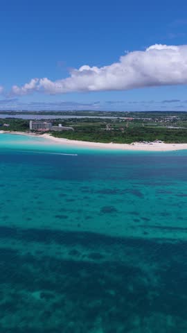 Rotating Aerial View (OKINAWA JAPAN ) - Yonaha Maehama Beach And Maehama Port With Hotels, Blue Water And A Boat On Miyako Island, Okinawa, Japan. Aerial Orbit Shot