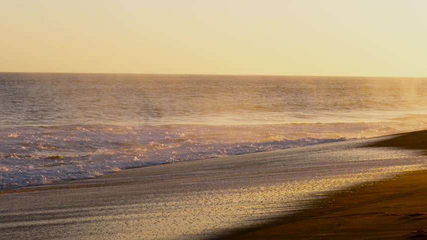 White wash rolling to shore at sunset on the beach