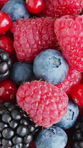 Mixed berries close-up macro raspberries blueberries blackberries redcurrants vibrant texture ripe juicy slow motion food photography healthy eating summer harvest