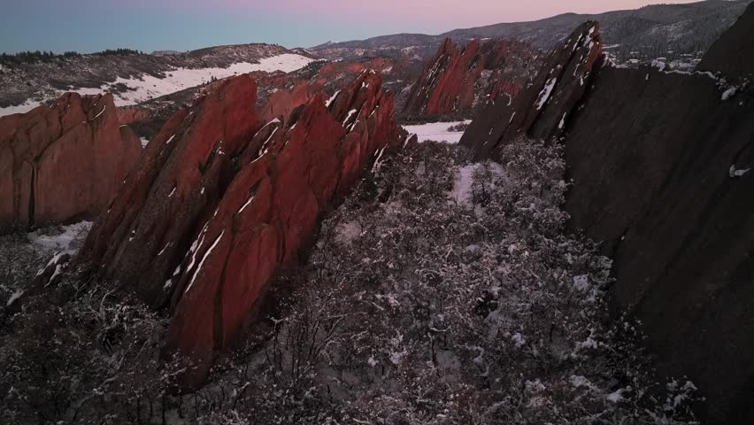 Spring Winter snow-covered Roxborough State Park Fountain Valley Trail jagged red rocks sandstone aerial drone landscape Denver Littleton Sterling Ranch Colorado Front Range Rocky Mountains forward up