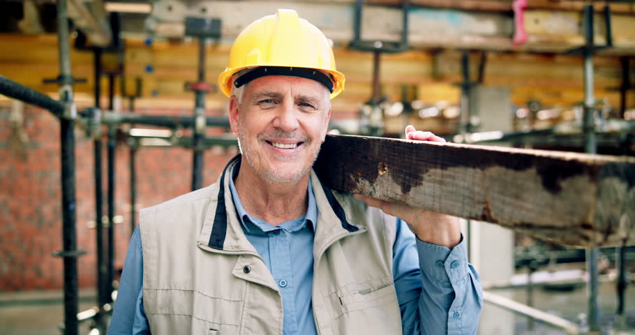 Construction, face or man on site with plank, positive attitude or pride as industrial worker. Happy, mature person or engineer with wood material, about us and confidence in architecture industry.